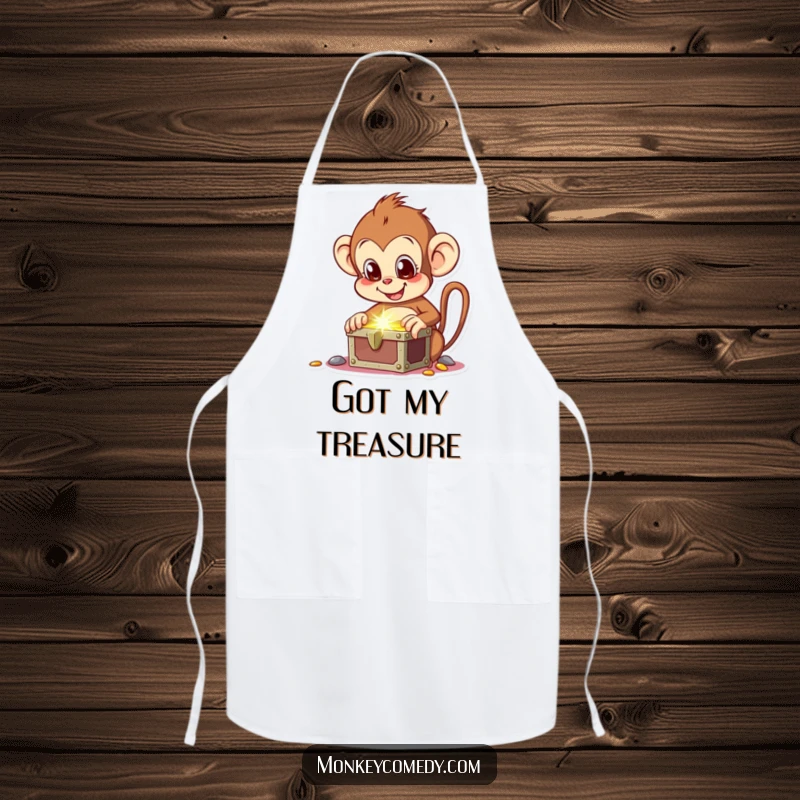 Funny apron showing a delighted monkey finding a treasure chest, perfect for kitchen adventures and cooking fun.