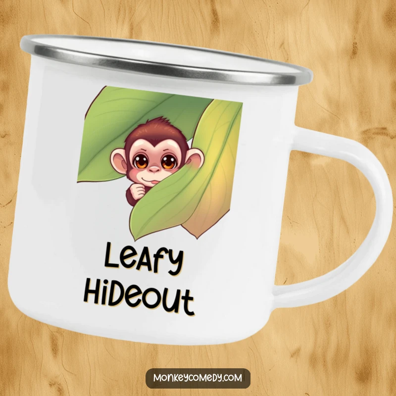 Funny monkey camping mug showing a small monkey with curious eyes peeking from behind a large, colorful leaf, perfect for outdoor fun.