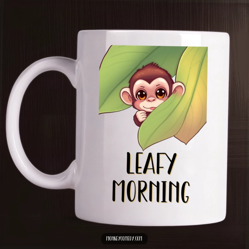 Funny monkey mug featuring small monkey with curious eyes peeking from behind a large, colorful leaf, a charming and humorous design.