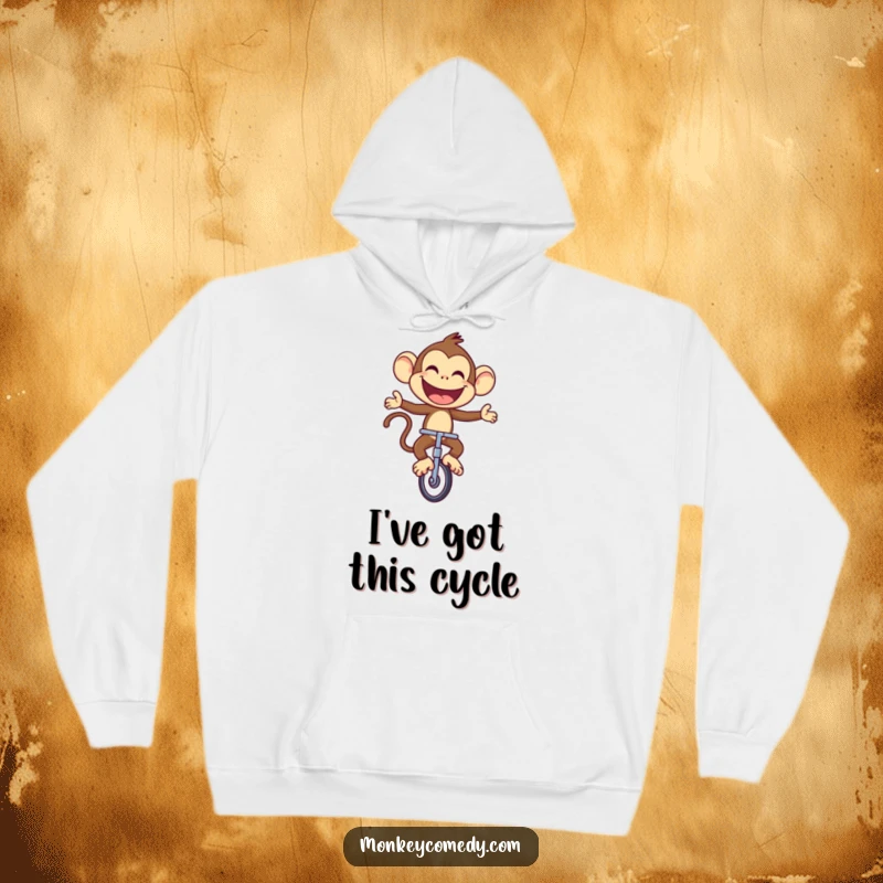 Funny Monkey Hoodie: A joyful monkey rides a unicycle with a large, proud smile, exuding fun and confidence.