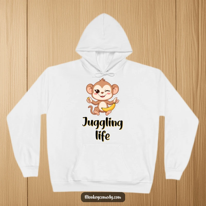 Funny Kawaii Monkey Juggling Hoodie: A soft, warm hoodie showcasing a cute monkey juggling bananas with a mischievous wink.
